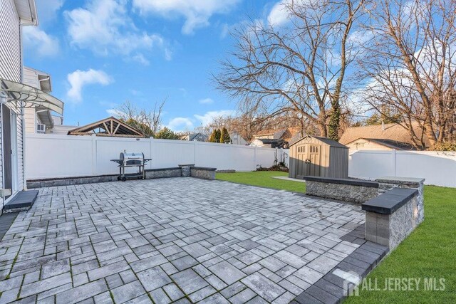 view of patio / terrace featuring a storage unit