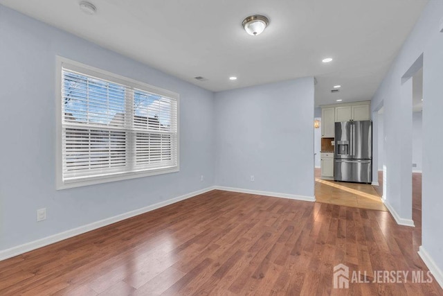 unfurnished room with light hardwood / wood-style flooring