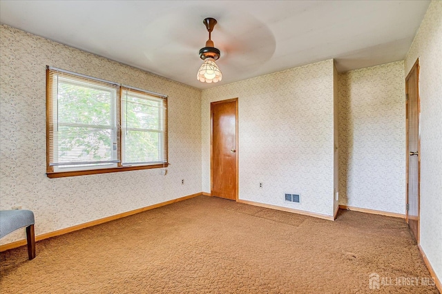 108 Smith St, South Plainfield, NJ 07080 - carpeted empty room featuring wallpapered walls and a ceiling fan