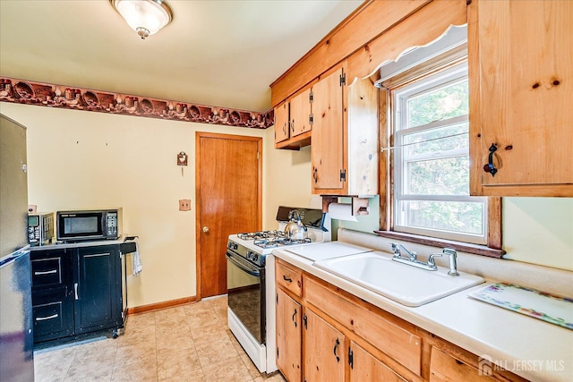 108 Smith St, South Plainfield, NJ 07080 - kitchen featuring gas range oven, black microwave, light countertops, and light tile patterned floors