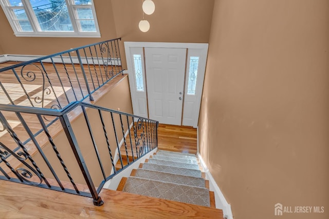 14 Ridgeview Rd, Jamesburg, NJ 08831 - entrance foyer featuring wood finished floors, healthy amount of natural light, baseboard heating, and baseboards
