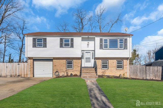 bi-level home featuring a garage and a front yard