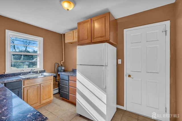 14 Ridgeview Rd, Jamesburg, NJ 08831 - kitchen with freestanding refrigerator, a sink, light tile patterned flooring, a baseboard heating unit, and dark countertops
