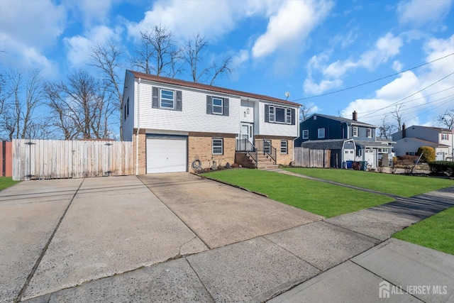 14 Ridgeview Rd, Jamesburg, NJ 08831 - raised ranch featuring brick siding, concrete driveway, an attached garage, and a gate