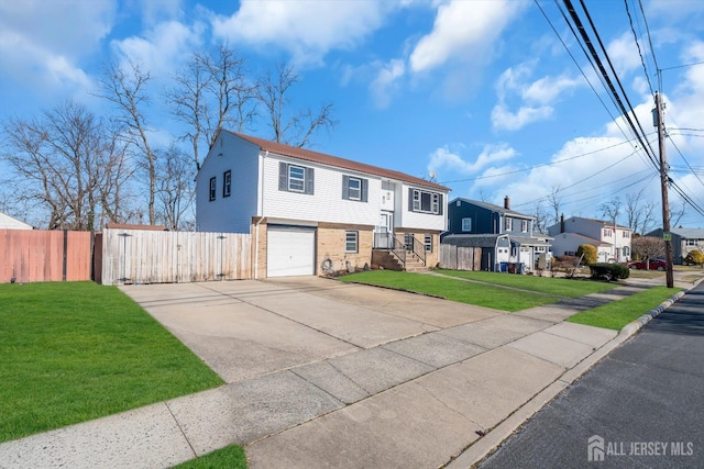 14 Ridgeview Rd, Jamesburg, NJ 08831 - raised ranch with driveway, an attached garage, a gate, a residential view, and brick siding
