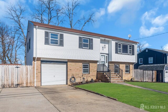 14 Ridgeview Rd, Jamesburg, NJ 08831 - raised ranch with brick siding, an attached garage, and concrete driveway