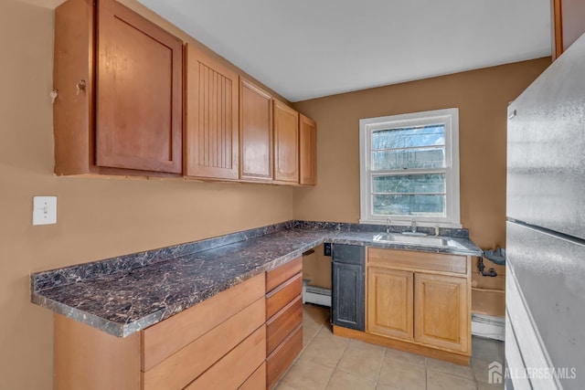 14 Ridgeview Rd, Jamesburg, NJ 08831 - kitchen with a sink, freestanding refrigerator, a baseboard heating unit, and light tile patterned flooring