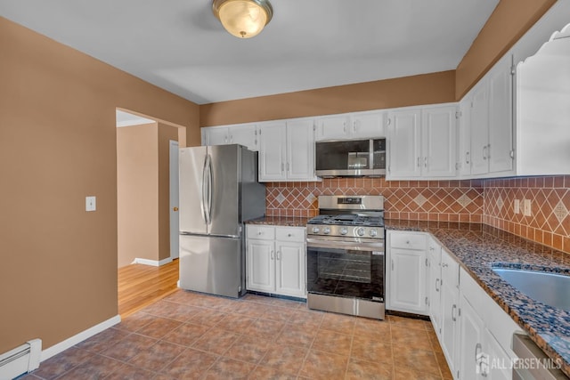 14 Ridgeview Rd, Jamesburg, NJ 08831 - kitchen with stainless steel appliances, baseboard heating, white cabinetry, decorative backsplash, and baseboards