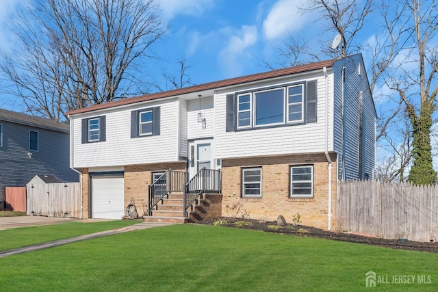 split foyer home with a garage and a front yard