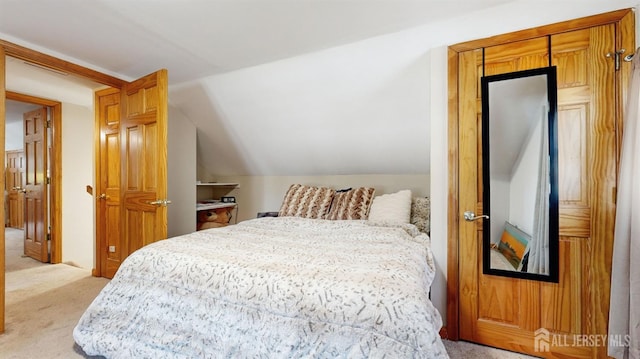 bedroom with light carpet and vaulted ceiling