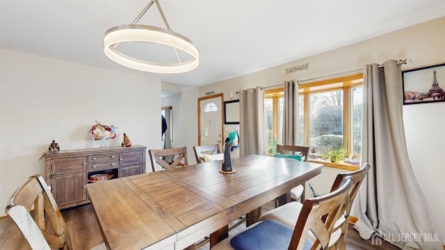 dining space with hardwood / wood-style flooring