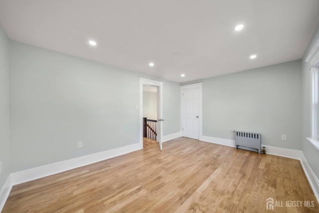 657 Amboy Ave, Edison, NJ 08837 - unfurnished room with radiator heating unit, recessed lighting, light wood finished floors, and baseboards