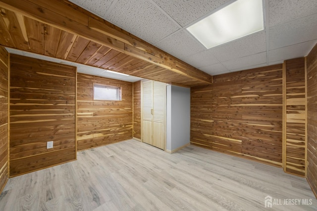 657 Amboy Ave, Edison, NJ 08837 - basement featuring wood walls, light wood finished floors, and baseboards