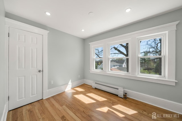 657 Amboy Ave, Edison, NJ 08837 - spare room with baseboard heating, baseboards, wood finished floors, and recessed lighting
