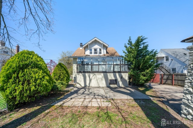 657 Amboy Ave, Edison, NJ 08837 - view of front of home with a patio, a sunroom, and a chimney