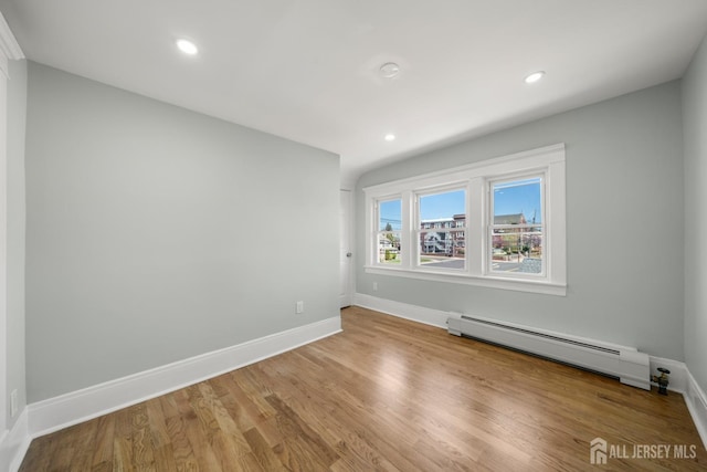 657 Amboy Ave, Edison, NJ 08837 - spare room featuring a baseboard radiator, baseboards, recessed lighting, and wood finished floors