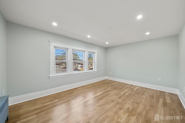 657 Amboy Ave, Edison, NJ 08837 - spare room with light wood finished floors, radiator heating unit, recessed lighting, and baseboards