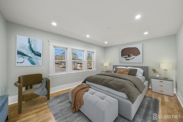 657 Amboy Ave, Edison, NJ 08837 - bedroom with light wood-style flooring, baseboards, recessed lighting, and radiator