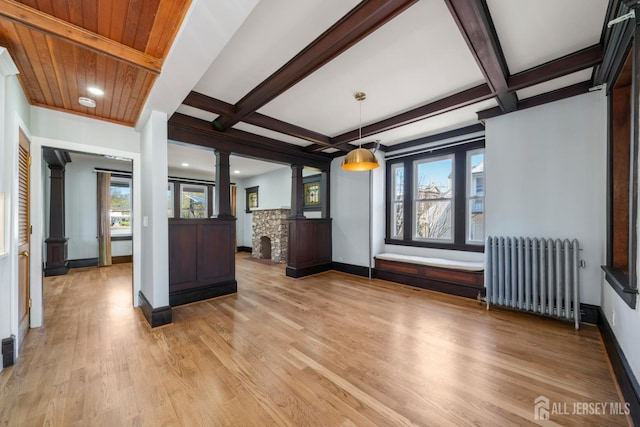 657 Amboy Ave, Edison, NJ 08837 - unfurnished living room featuring radiator heating unit, ornate columns, light wood-style flooring, beam ceiling, and coffered ceiling