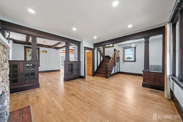 657 Amboy Ave, Edison, NJ 08837 - unfurnished living room with decorative columns, baseboards, light wood-style floors, stairway, and recessed lighting