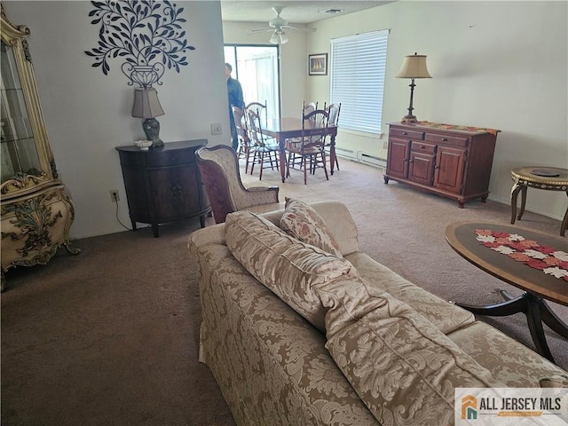 carpeted living room featuring ceiling fan and baseboard heating