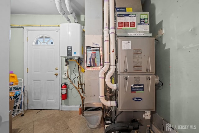 utility room featuring water heater