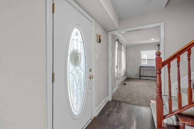 foyer entrance with dark hardwood / wood-style floors