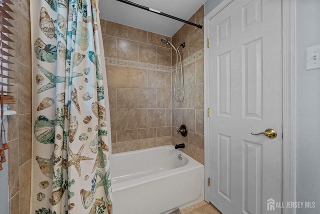 bathroom featuring tile patterned flooring and shower / bath combination with curtain