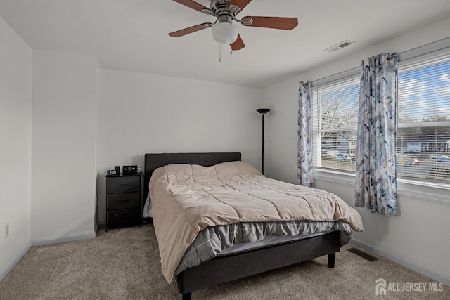 bedroom with a ceiling fan, baseboards, visible vents, and carpet flooring