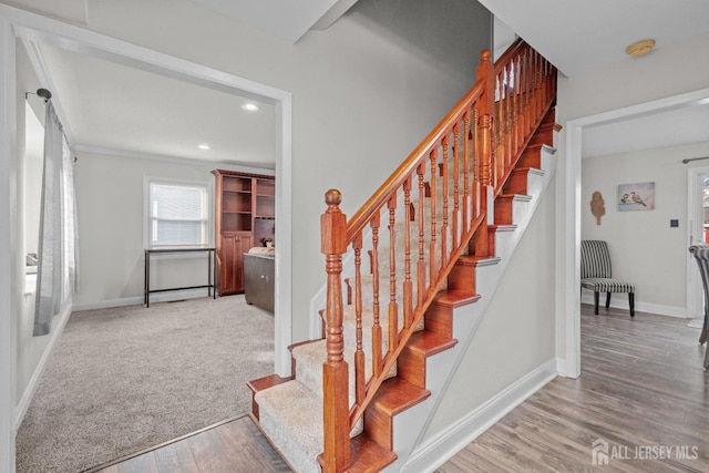 stairway featuring carpet floors, recessed lighting, wood finished floors, and baseboards