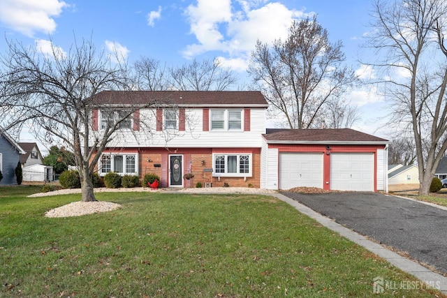 colonial house with aphalt driveway, a front lawn, an attached garage, and brick siding