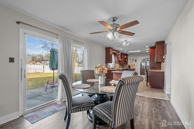 dining space featuring ceiling fan, recessed lighting, wood finished floors, and baseboards