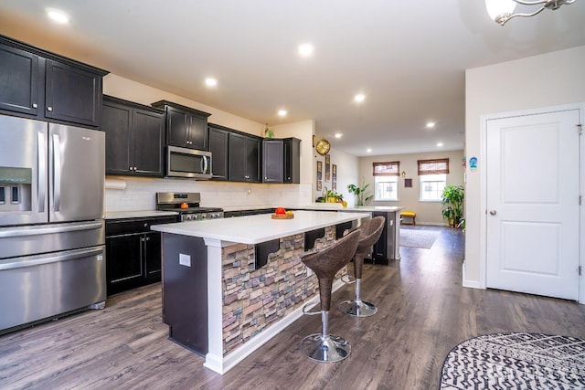 102 Matutina Rd, Monroe, NJ 08831 - kitchen with appliances with stainless steel finishes, a breakfast bar, light countertops, a peninsula, and a kitchen island