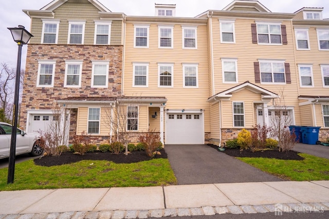 102 Matutina Rd, Monroe, NJ 08831 - view of front of house featuring stone siding, a garage, and asphalt driveway