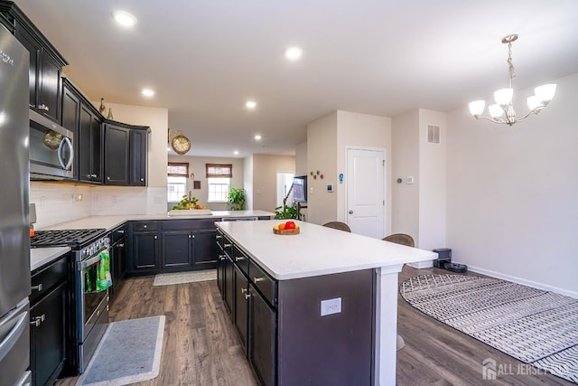 102 Matutina Rd, Monroe, NJ 08831 - kitchen with appliances with stainless steel finishes, dark wood-style flooring, light countertops, a chandelier, and recessed lighting