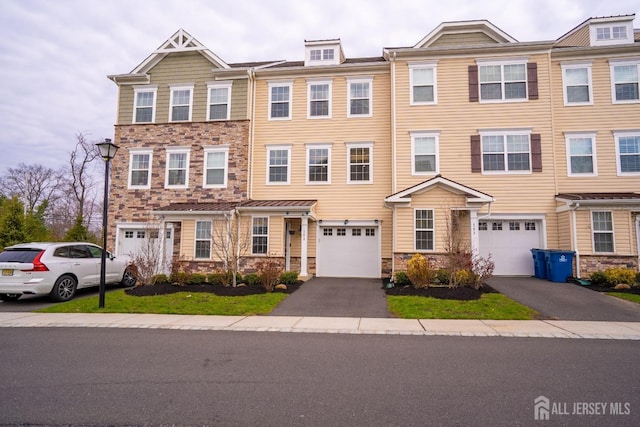 102 Matutina Rd, Monroe, NJ 08831 - townhome / multi-family property with stone siding, a garage, and driveway