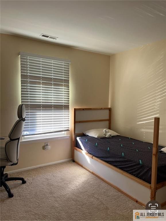 unfurnished bedroom featuring visible vents, carpet, and baseboards