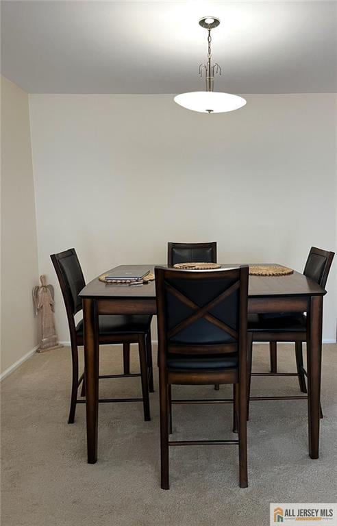 dining area featuring baseboards and carpet floors
