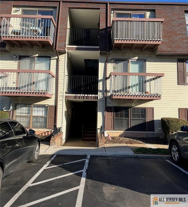 view of property featuring uncovered parking