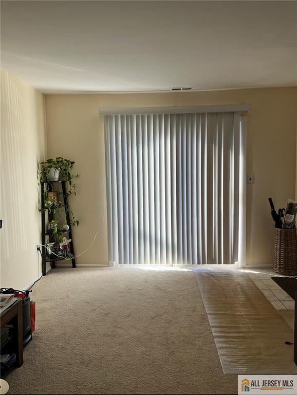 living area with radiator and carpet