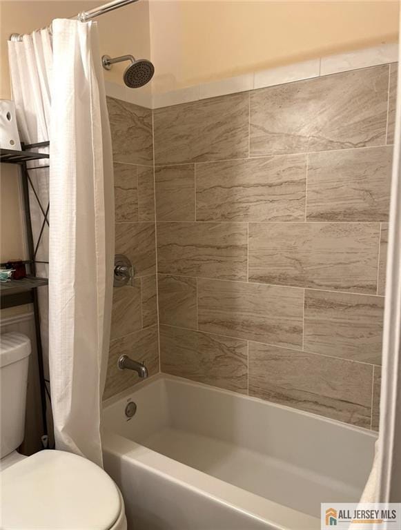 full bath featuring shower / bath combo with shower curtain and toilet