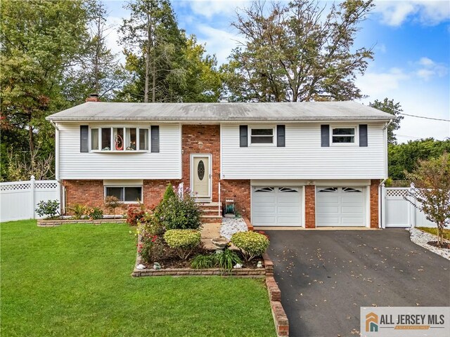 bi-level home with a front lawn and a garage