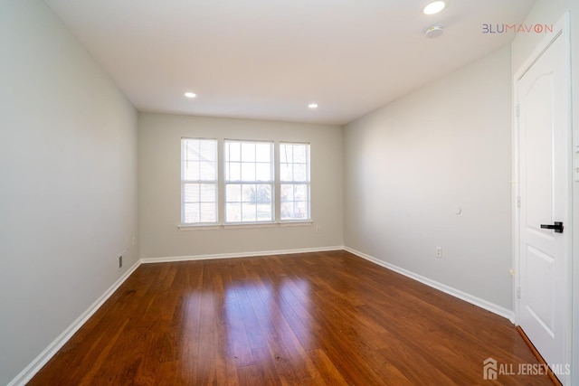 spare room with dark hardwood / wood-style flooring