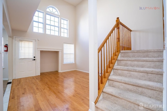 entryway with a high ceiling and hardwood / wood-style floors