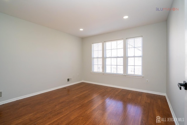 empty room featuring dark wood-type flooring