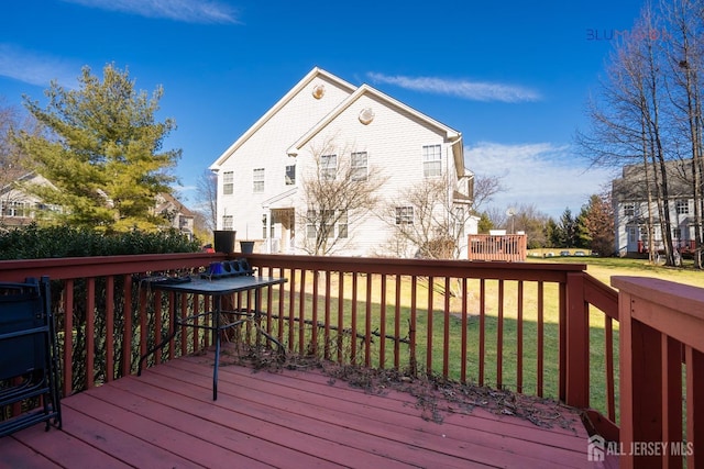 wooden terrace with a lawn