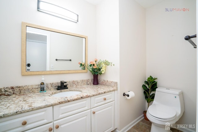 bathroom with toilet and vanity