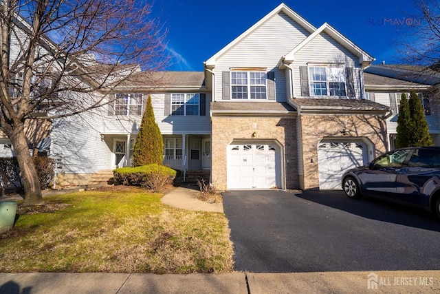 view of front of home with a garage and a front yard