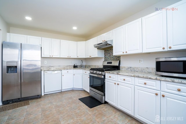 kitchen featuring light stone countertops, appliances with stainless steel finishes, white cabinetry, and sink