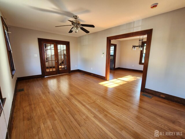 unfurnished room featuring ceiling fan, french doors, and light hardwood / wood-style floors